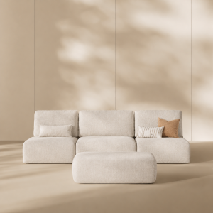White modular armless sofa with a matching ottoman in a minimalist beige living room.
