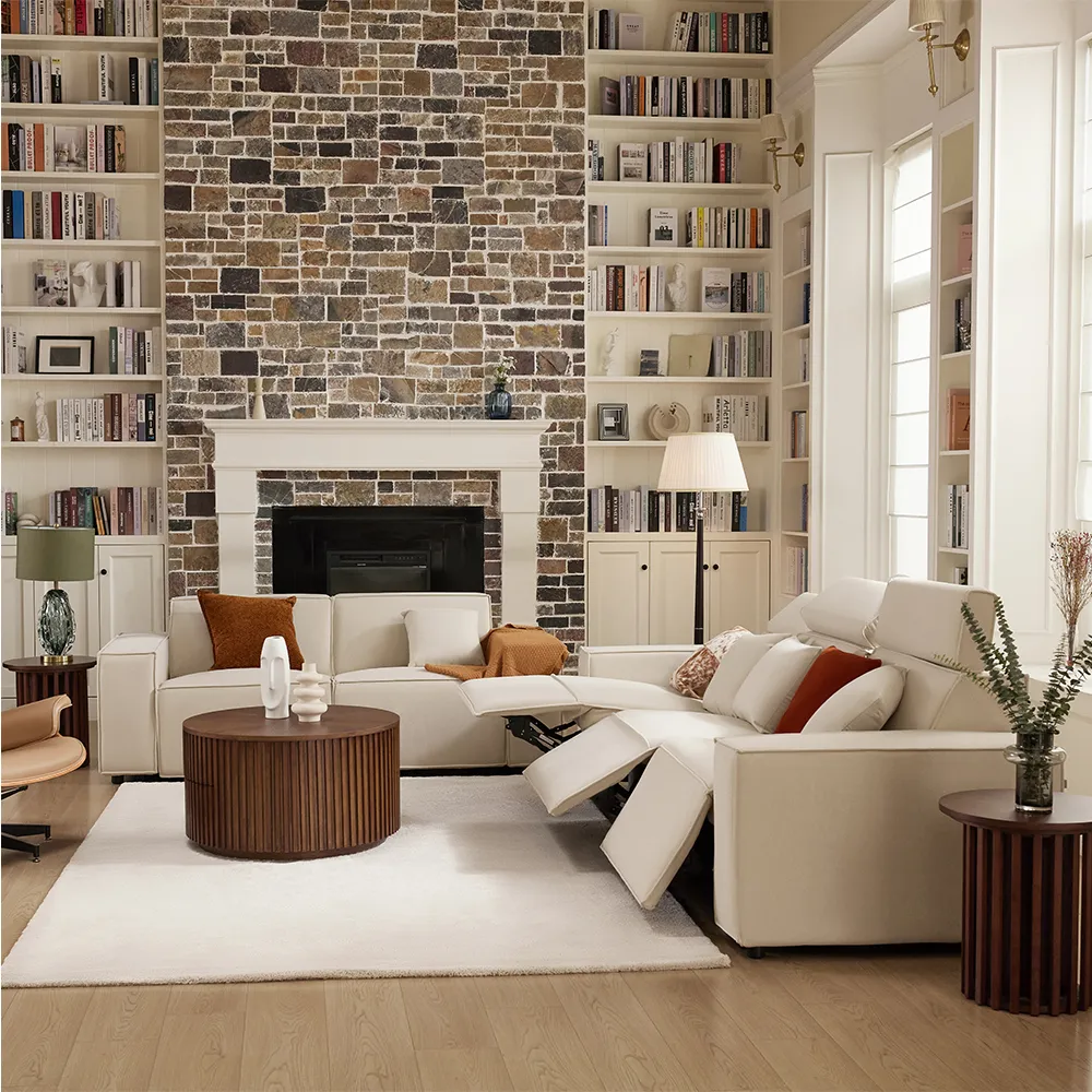 Large modular power recliner sofa in a cozy living room with built-in bookshelves, brick fireplace, and modern decor accents