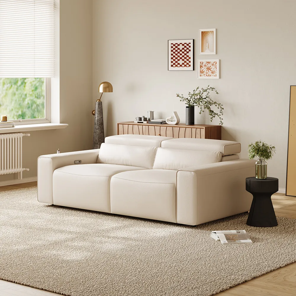 Contemporary leather power recliner sofa with adjustable headrests in a bright, cozy living space