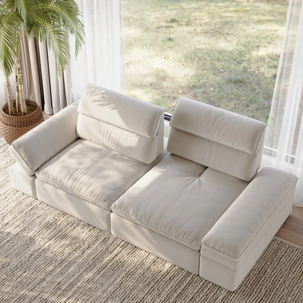 Beige sectional sofa with adjustable headrests, low arms, and a cozy woven rug, bathed in natural light from floor-to-ceiling windows