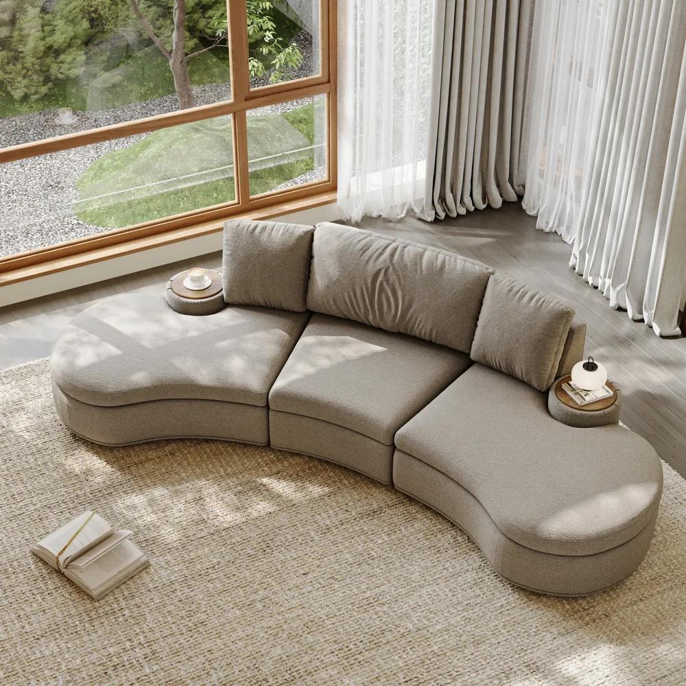 Top view of a curved beige modular sofa with built-in side tables, placed in a cozy living room with neutral tones

