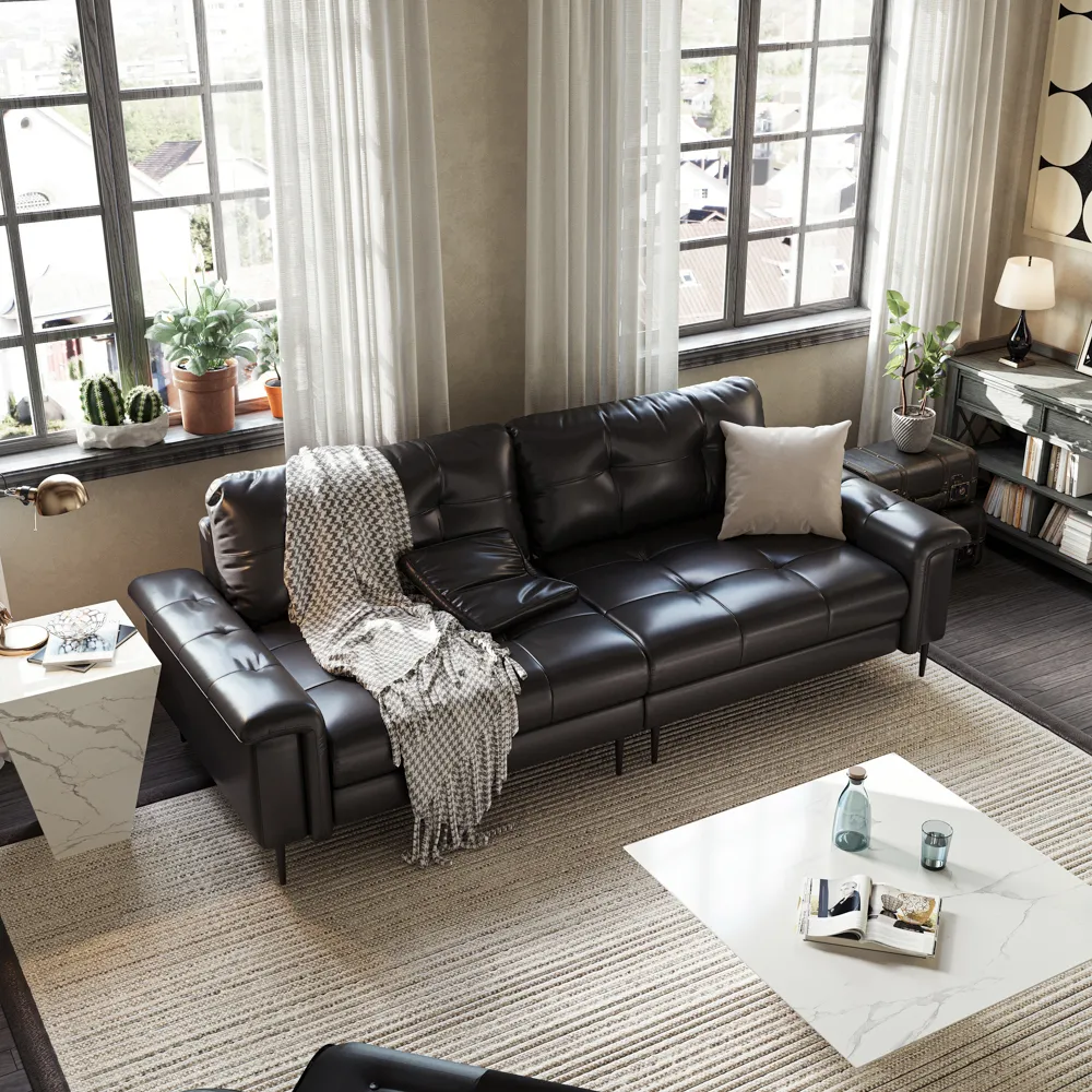 Dark brown faux leather sofa with tufted cushions and throw blanket, placed in a cozy living room with large windows and layered neutral textures.