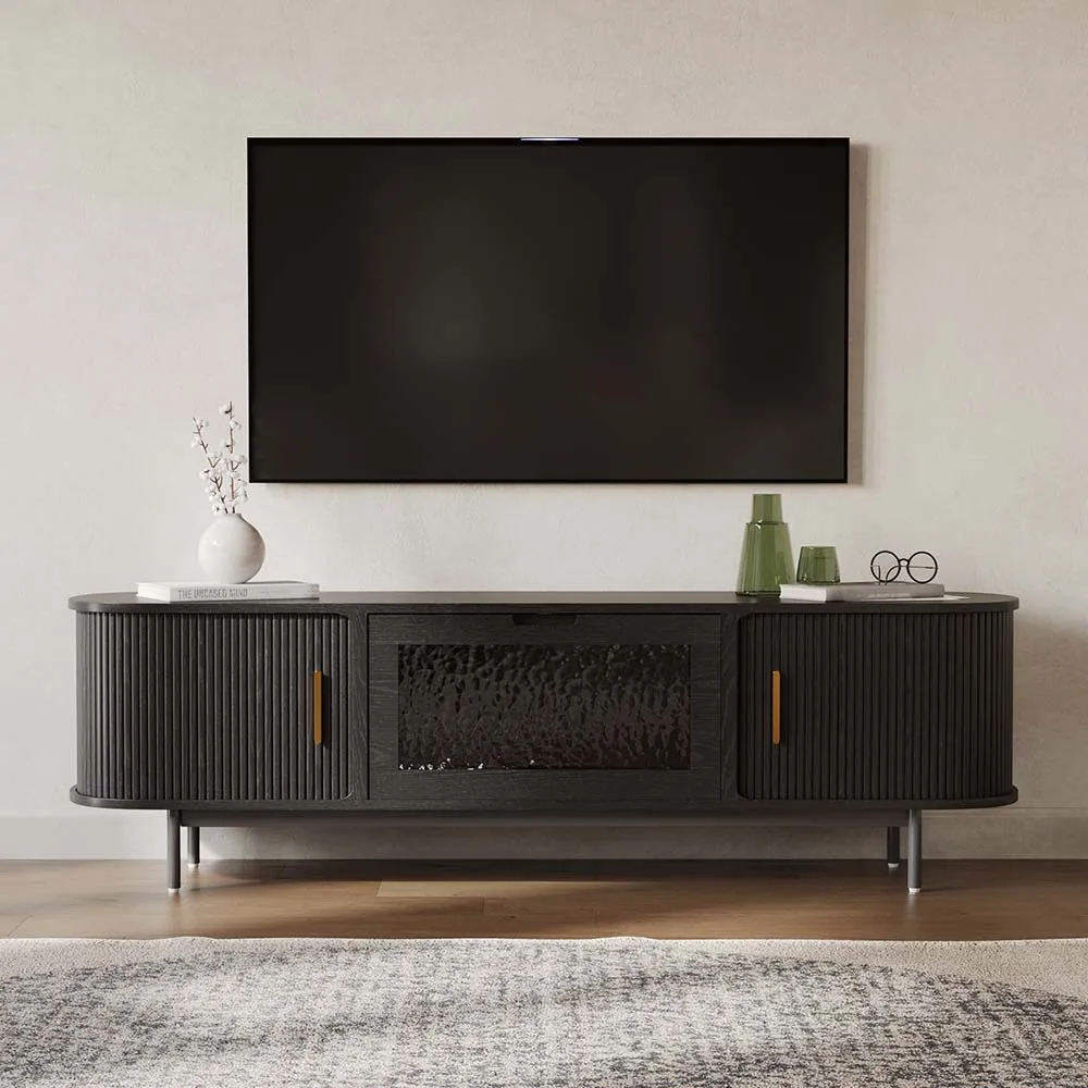 Contemporary black TV stand with fluted tambour doors and a central textured glass panel, placed beneath a wall-mounted flat-screen TV.
