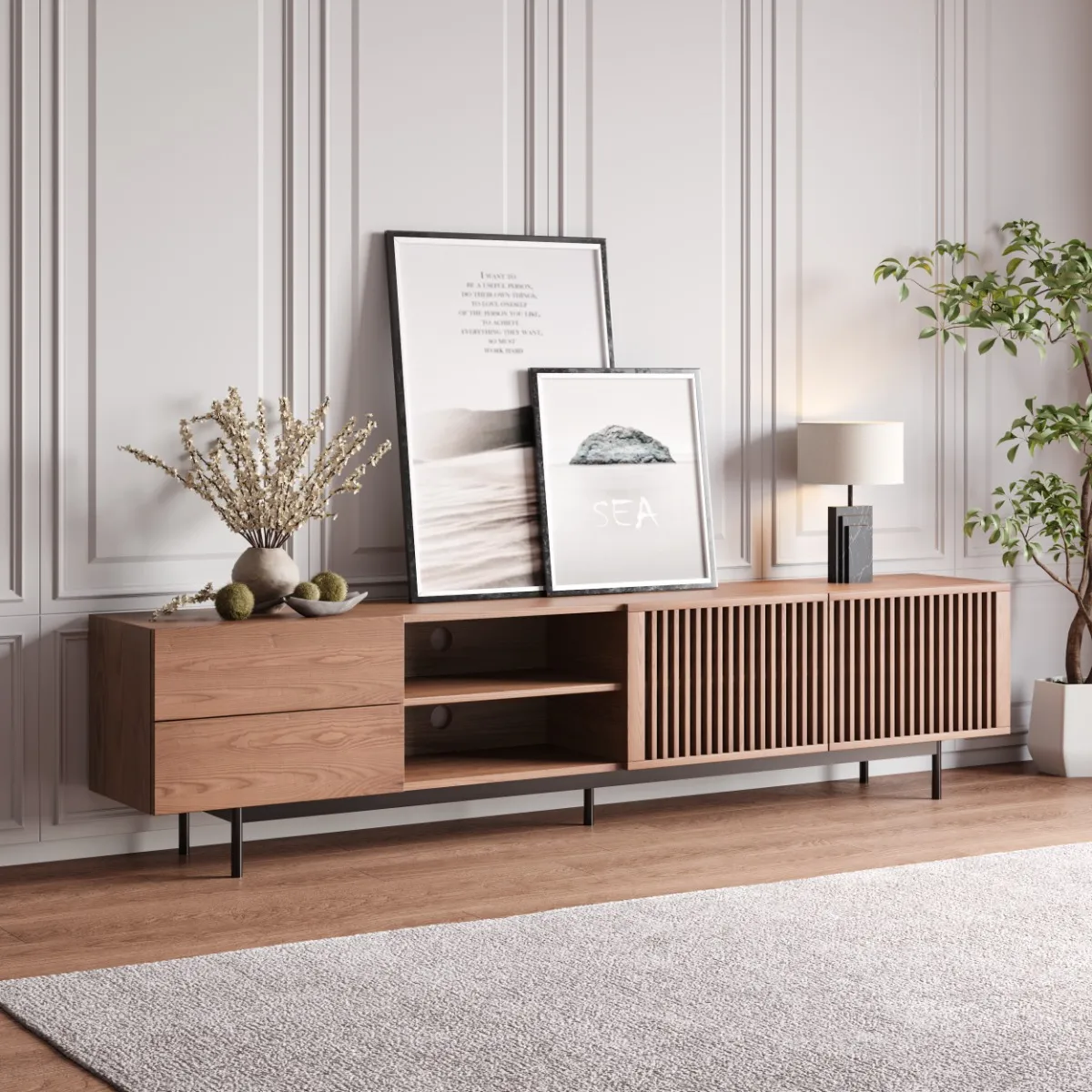 Contemporary wooden TV stand with decorative items, including framed pictures and a plant, set against a white paneled wall in a well-lit living room.