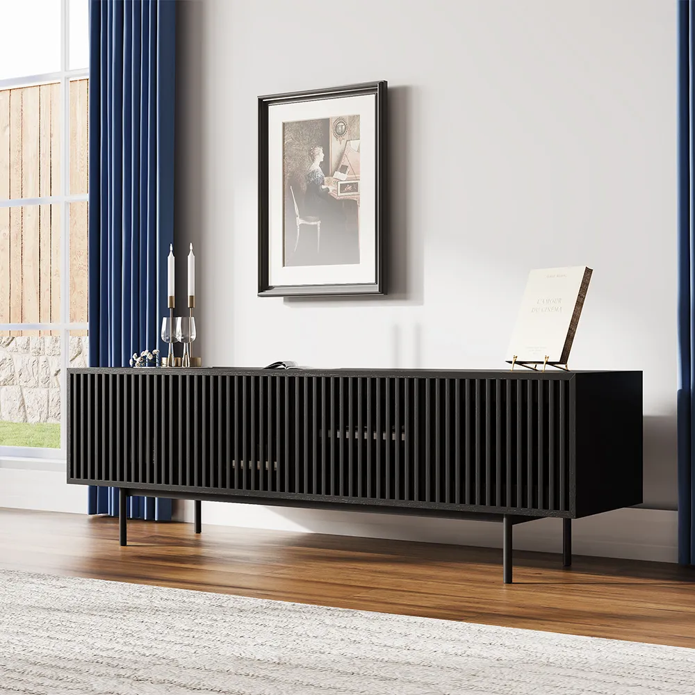 Sleek black TV cabinet with vertical slat doors and iron legs in a modern room with blue curtains