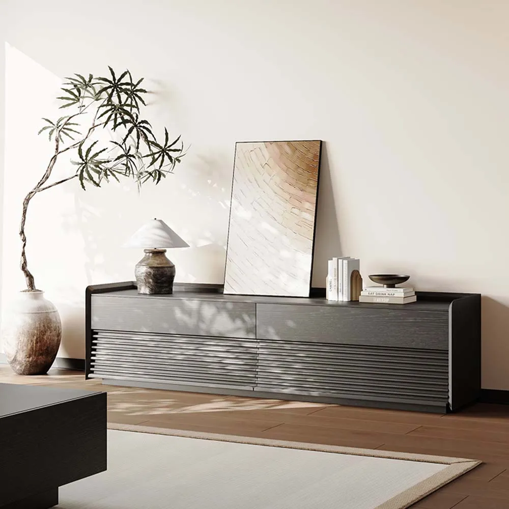 Contemporary low-profile dark wood TV stand with ribbed drawer fronts and decorative styling in sunlit room