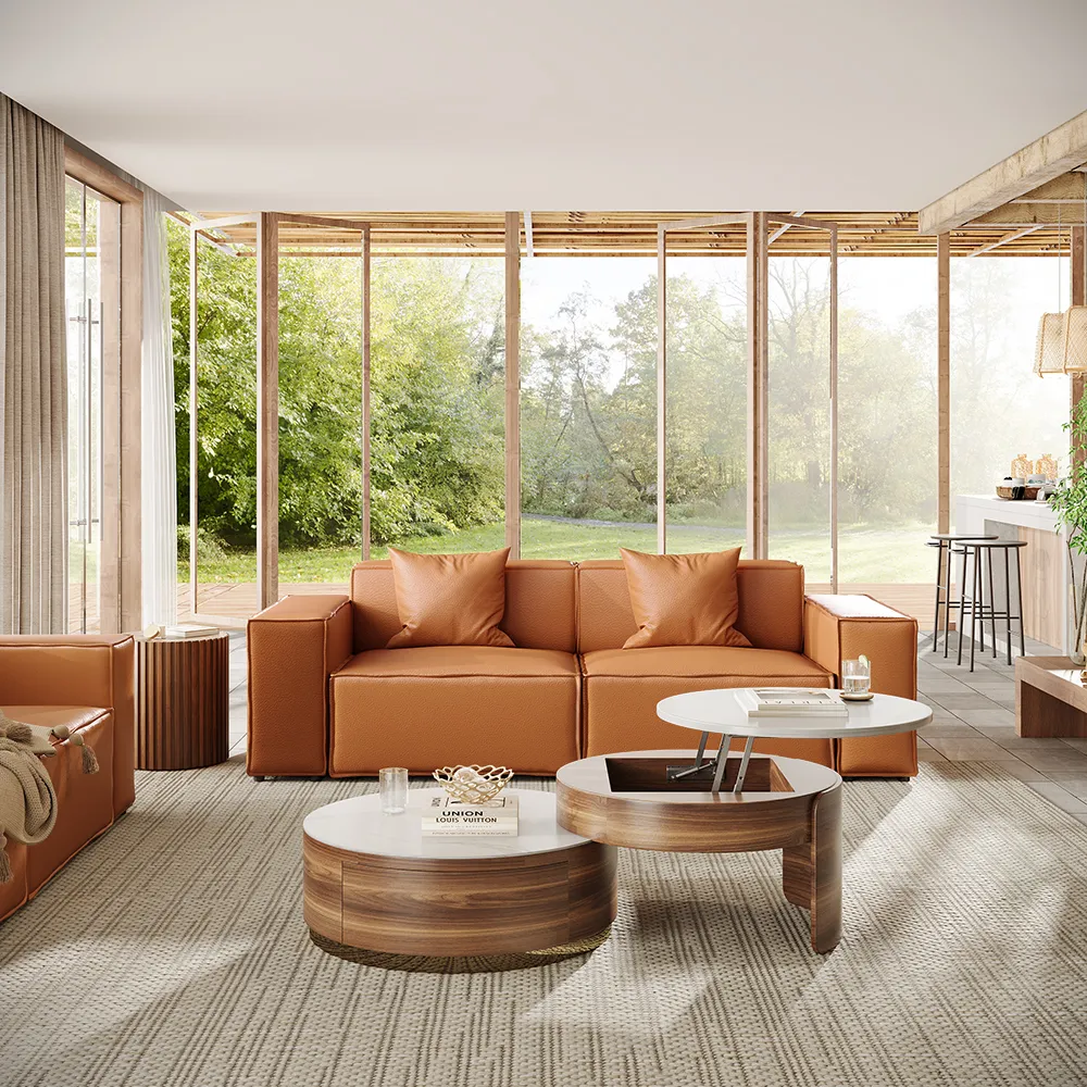 Contemporary tan leather modular sofa in a bright open-concept living room with floor-to-ceiling windows, paired with dual wood-and-white round coffee tables.