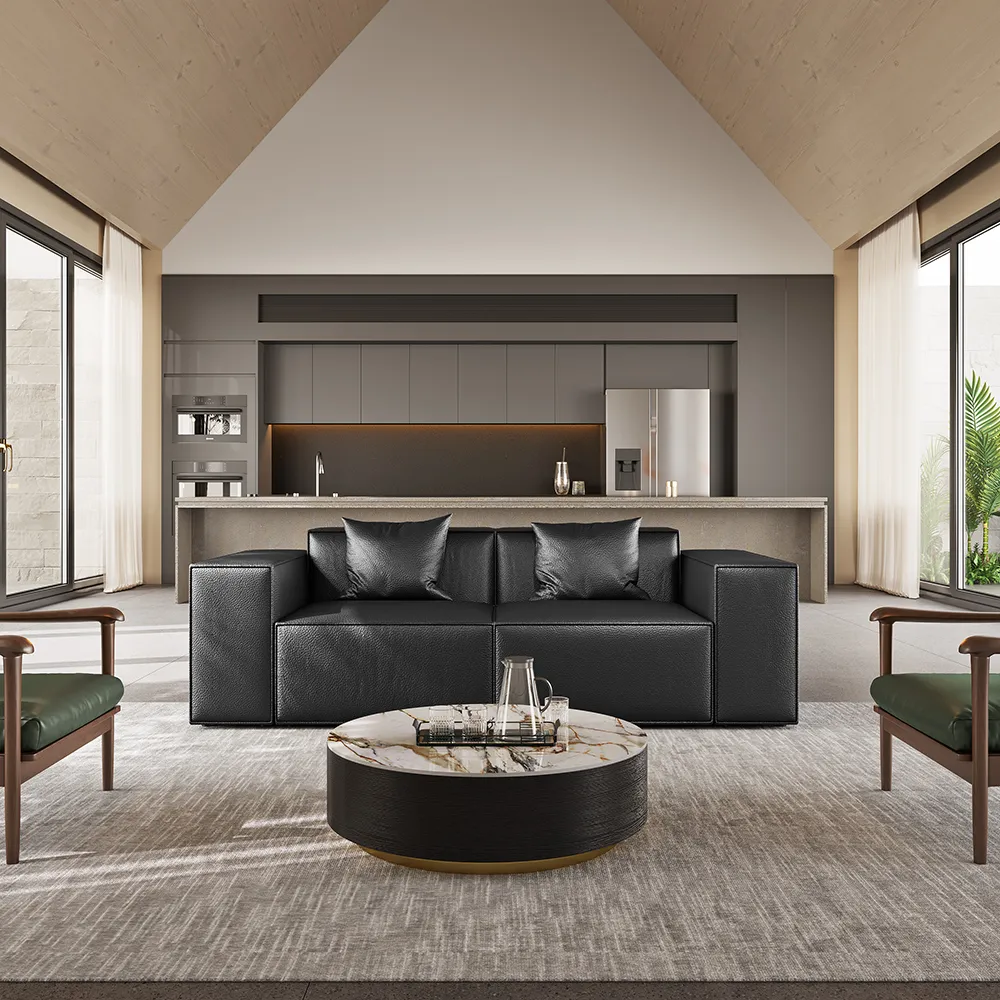 Contemporary black leather modular sofa in a spacious open-concept living room with vaulted ceiling and minimalist decor