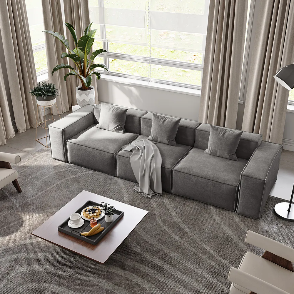 Light charcoal modular sofa with clean lines and minimal stitching, placed in a contemporary living room with beige curtains and geometric rug