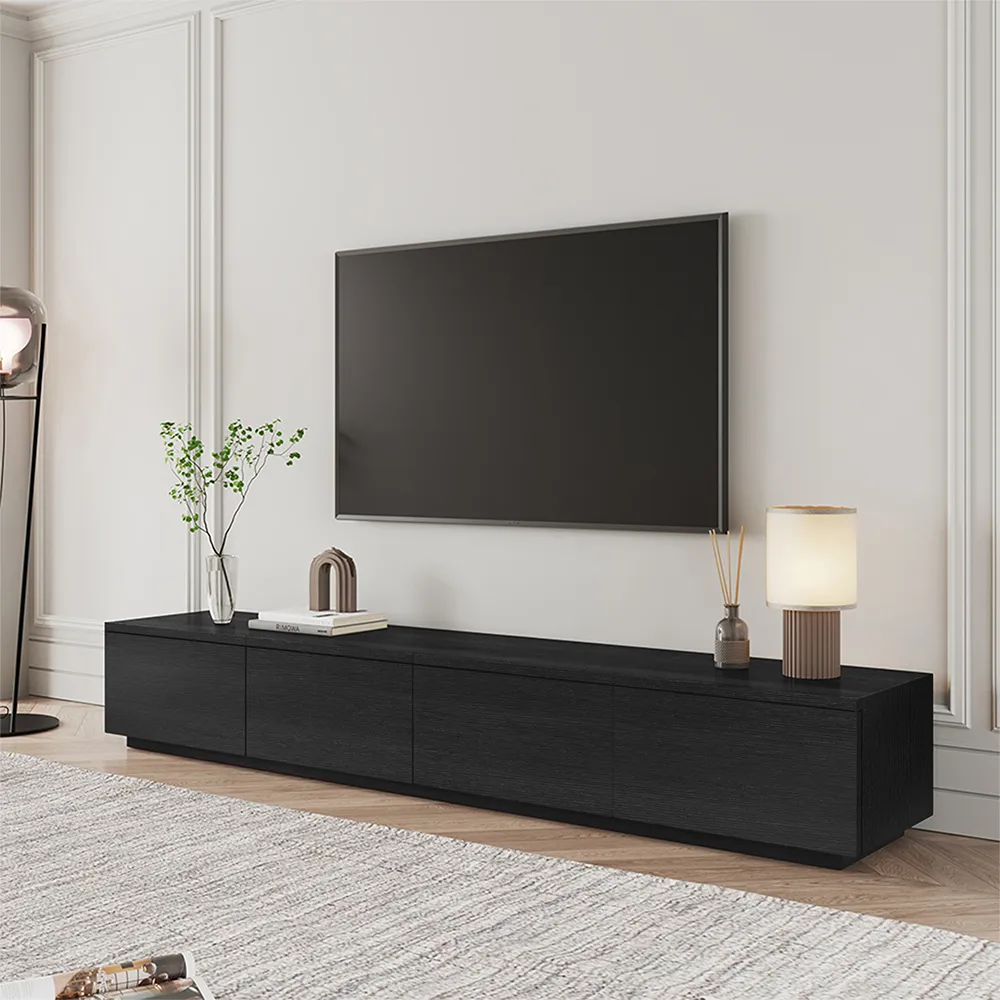 Minimalist black low-profile TV stand with clean lines and soft lighting in an elegant white wall setting
