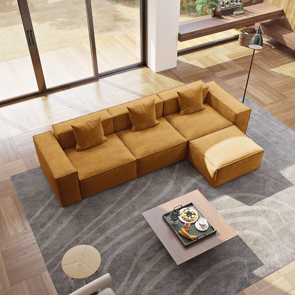 Top view of mustard modular sectional sofa with matching ottoman in a modern open-plan space featuring wood flooring and neutral decor