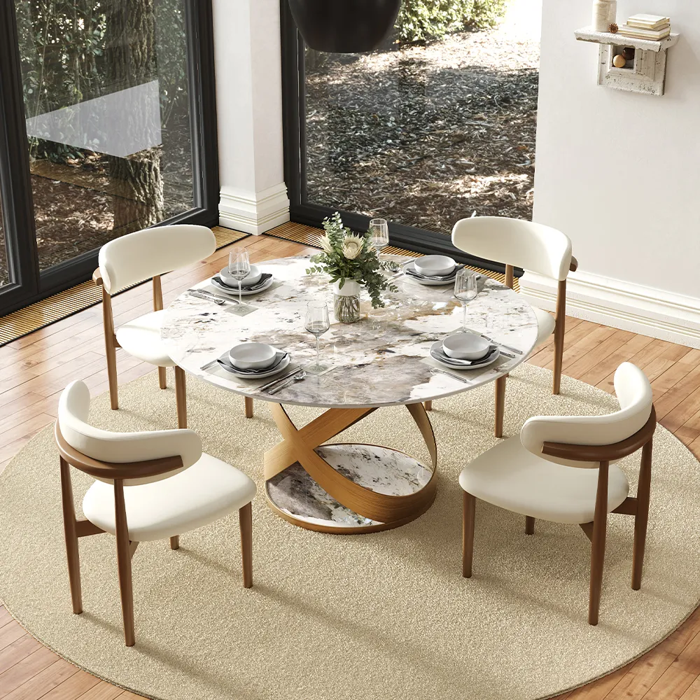 Round white sintered stone dining table with gold base, fully assembled and styled for four in a bright, modern family dining room.