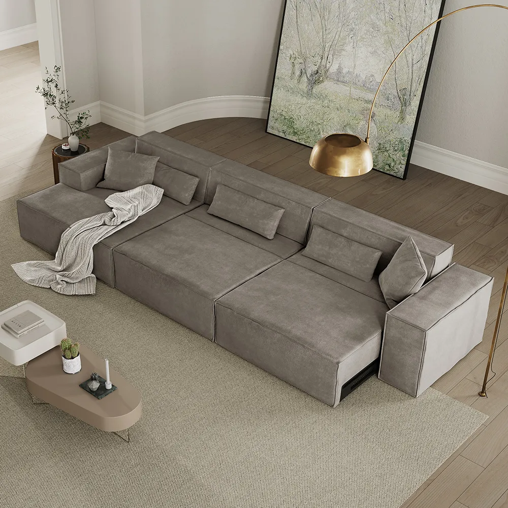 Contemporary gray modular sleeper sofa with clean lines, throw blanket, and accent lighting in a minimalist living room
