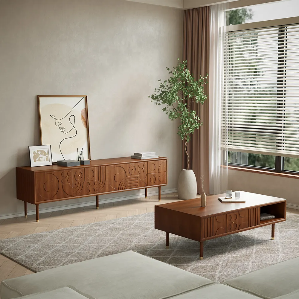 Mid-century modern living room with matching carved wood TV stand and coffee table, styled with minimalist art and indoor plant
