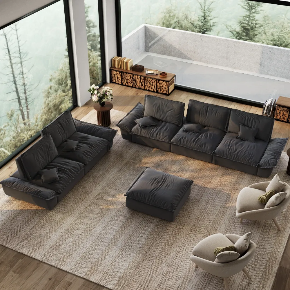Modern gray 2-3 seater sleeper sofa set with matching ottoman in spacious living room with large windows and forest view