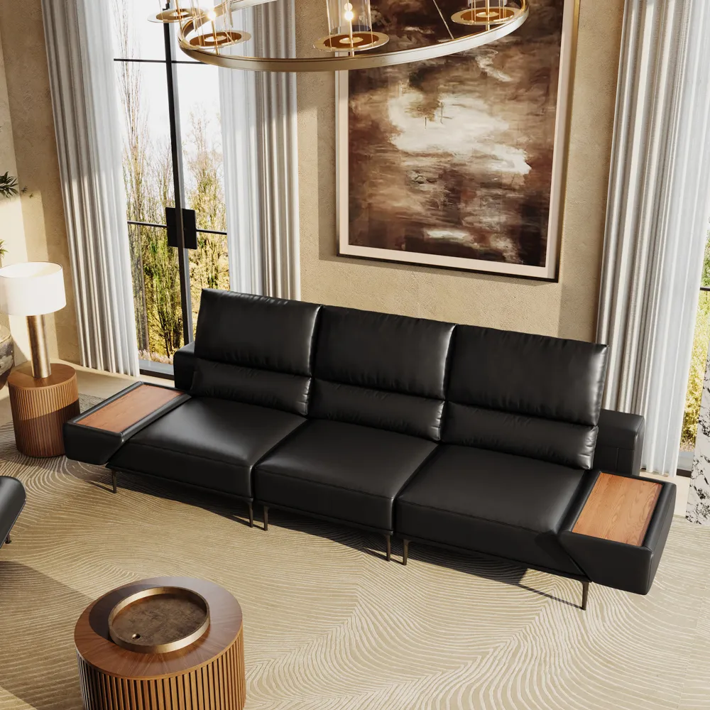 Contemporary black leather sofa with two built-in wood-tray armrests in a luxurious living room with modern lighting and artwork