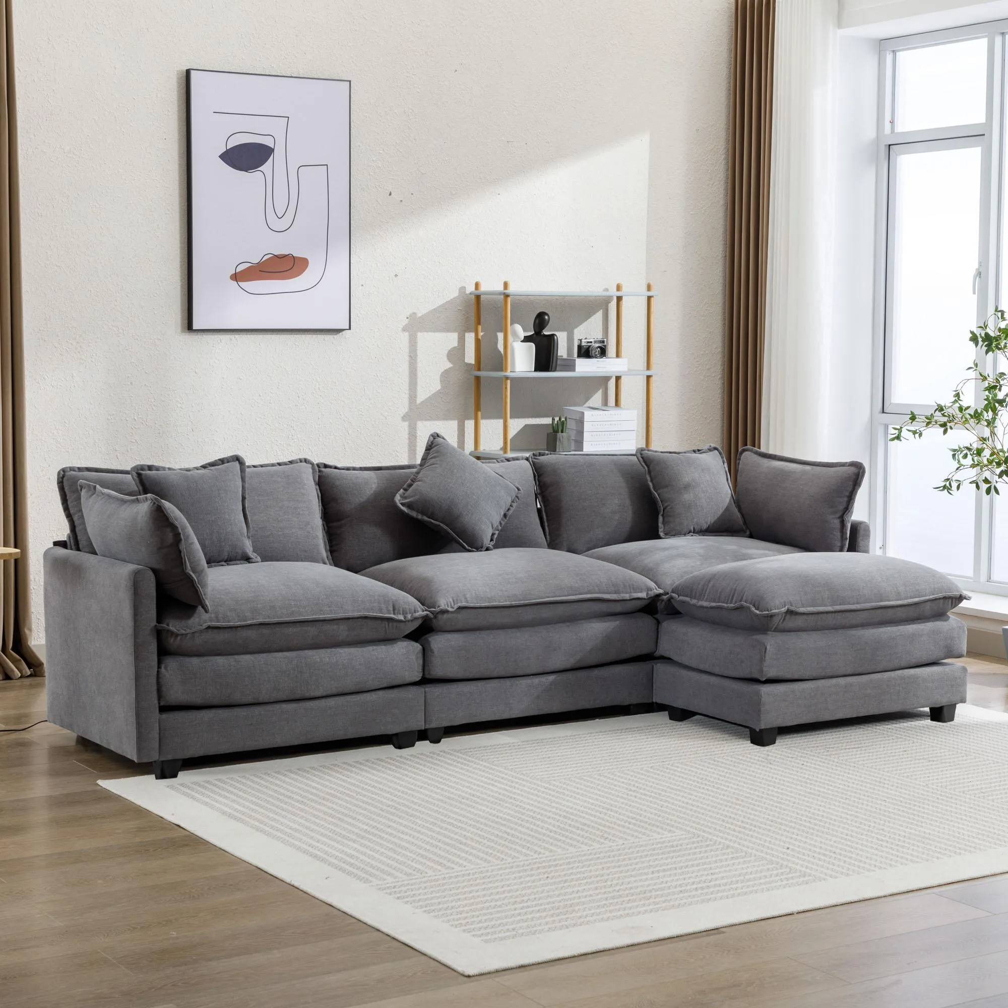 Gray L-shape chenille upholstered sofa with ottoman and 5 pillows in a sunlit room, styled with modern art and soft rug