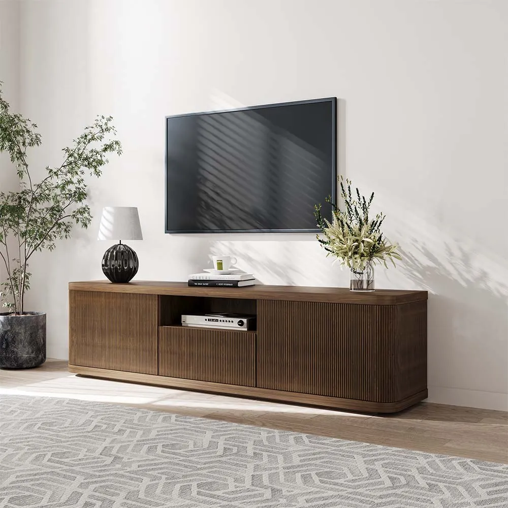 Walnut fluted TV stand in a minimal living room, paired with a wall-mounted TV and soft natural decor