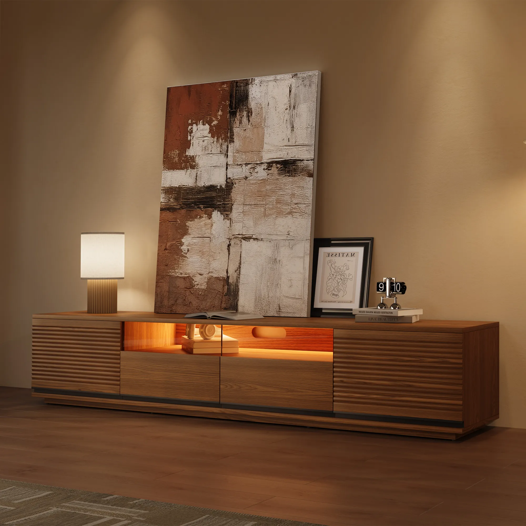 Walnut wood TV stand with ambient LED lighting and slatted doors, styled with artwork and modern décor in a cozy evening setting.