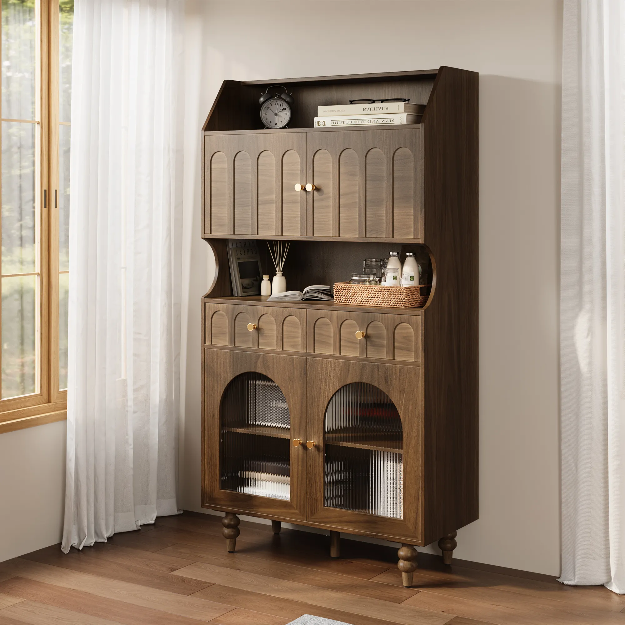 Mid-century walnut display cabinet with arched doors and open shelves, styled with books and decor by a sunlit window.