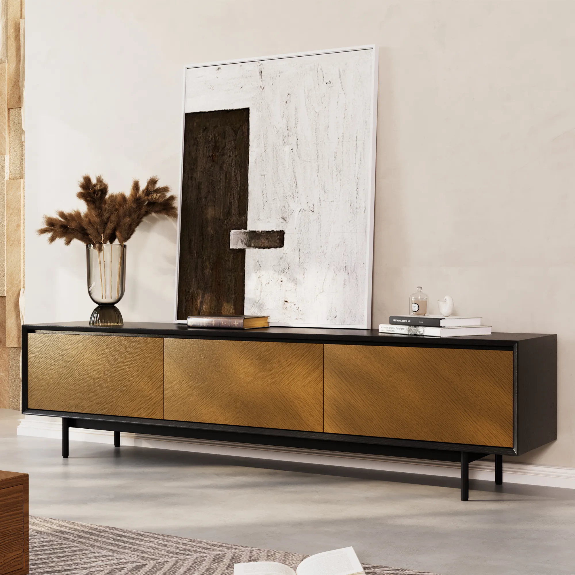 Mid-century modern TV stand with black frame and gold chevron wood drawers, styled with abstract wall art and decor accents