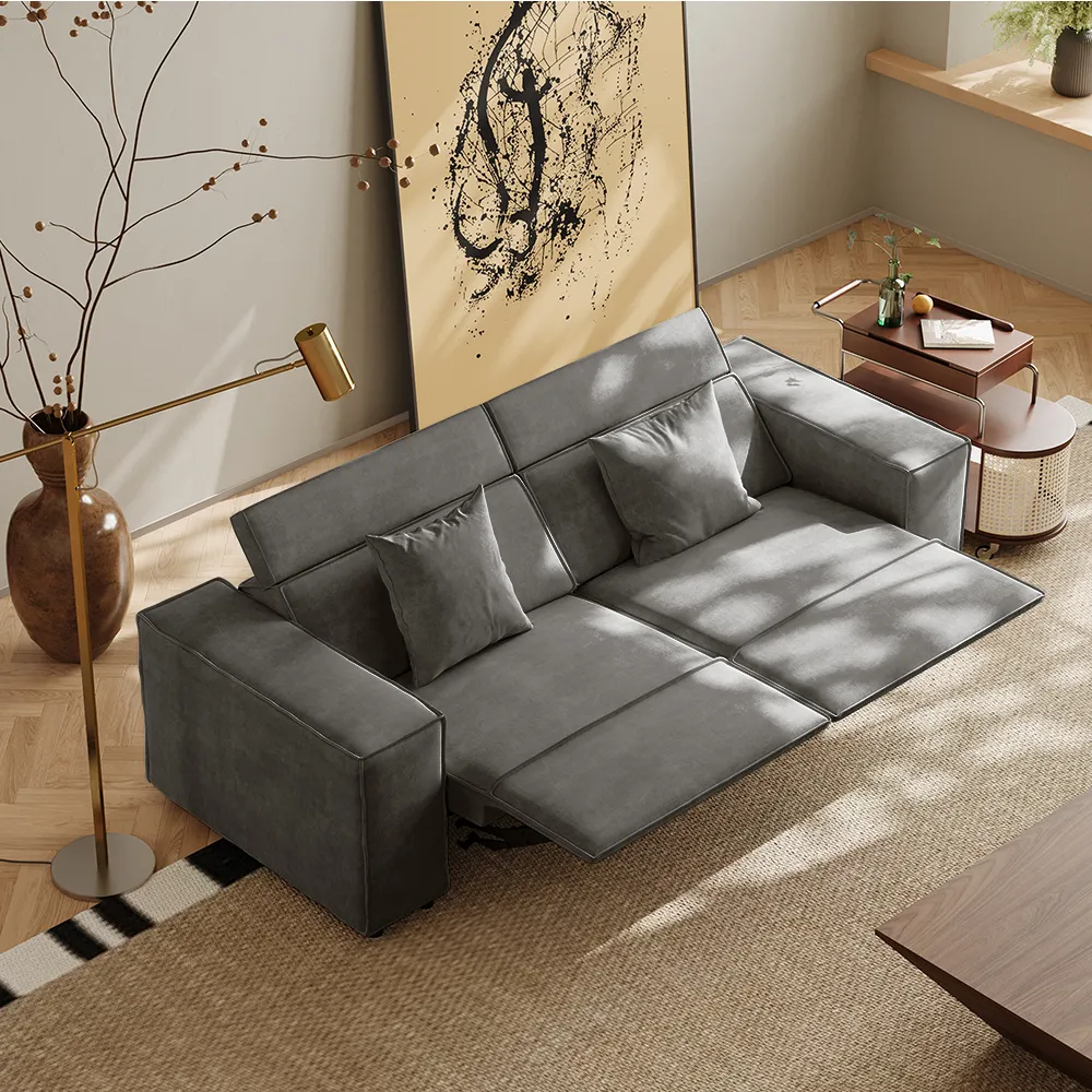 Sleek gray power recliner sofa with adjustable leg rests and square armrests, placed in a minimalist living room with warm natural lighting and abstract wall art.