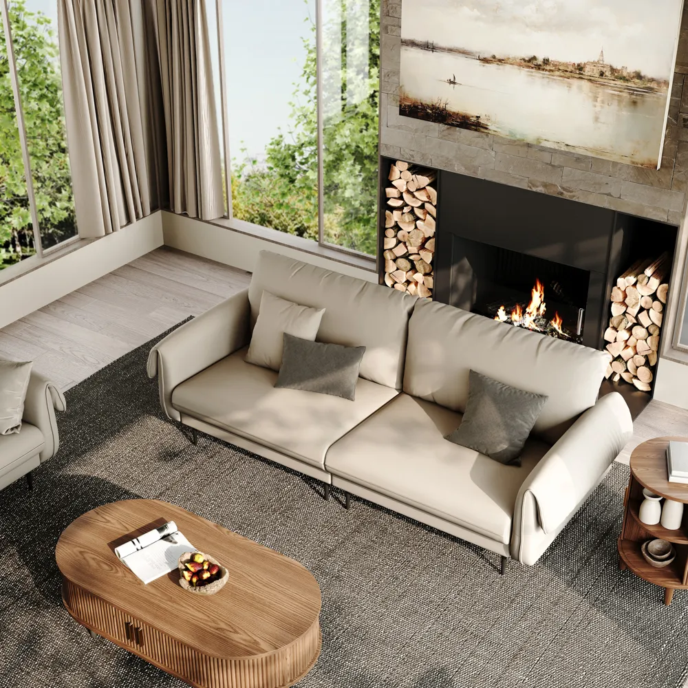 Top view of a modern beige sofa with curved armrests in front of a fireplace, styled with neutral pillows and a wooden coffee table