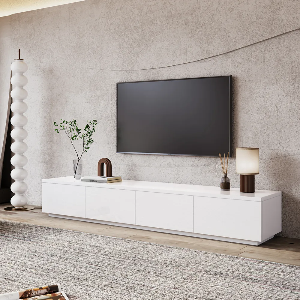 Modern low-profile white TV stand with clean lines and closed storage, styled under a wall-mounted flat-screen TV in a minimalist living room