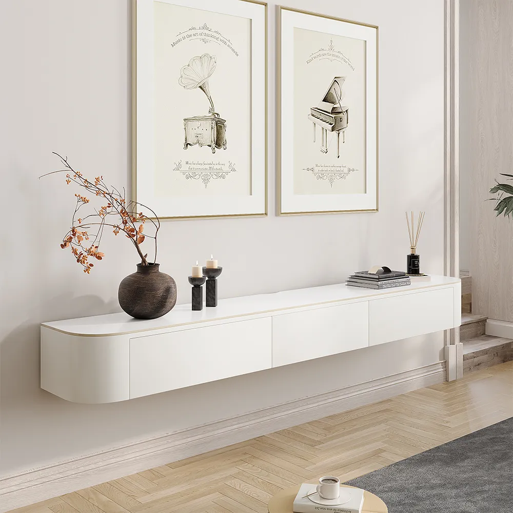 Wall-mounted white floating TV stand with rounded corners and seamless drawers, set in a light-toned modern interior