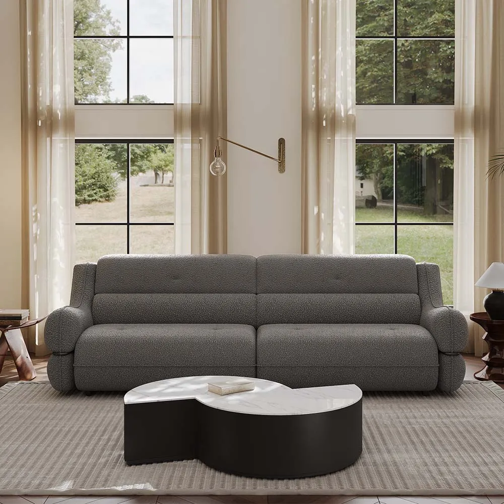 Front view of modern deep-seat boucle sofa in textured gray, placed in a serene neutral-toned living room with tall curtains and minimalist wall sconce