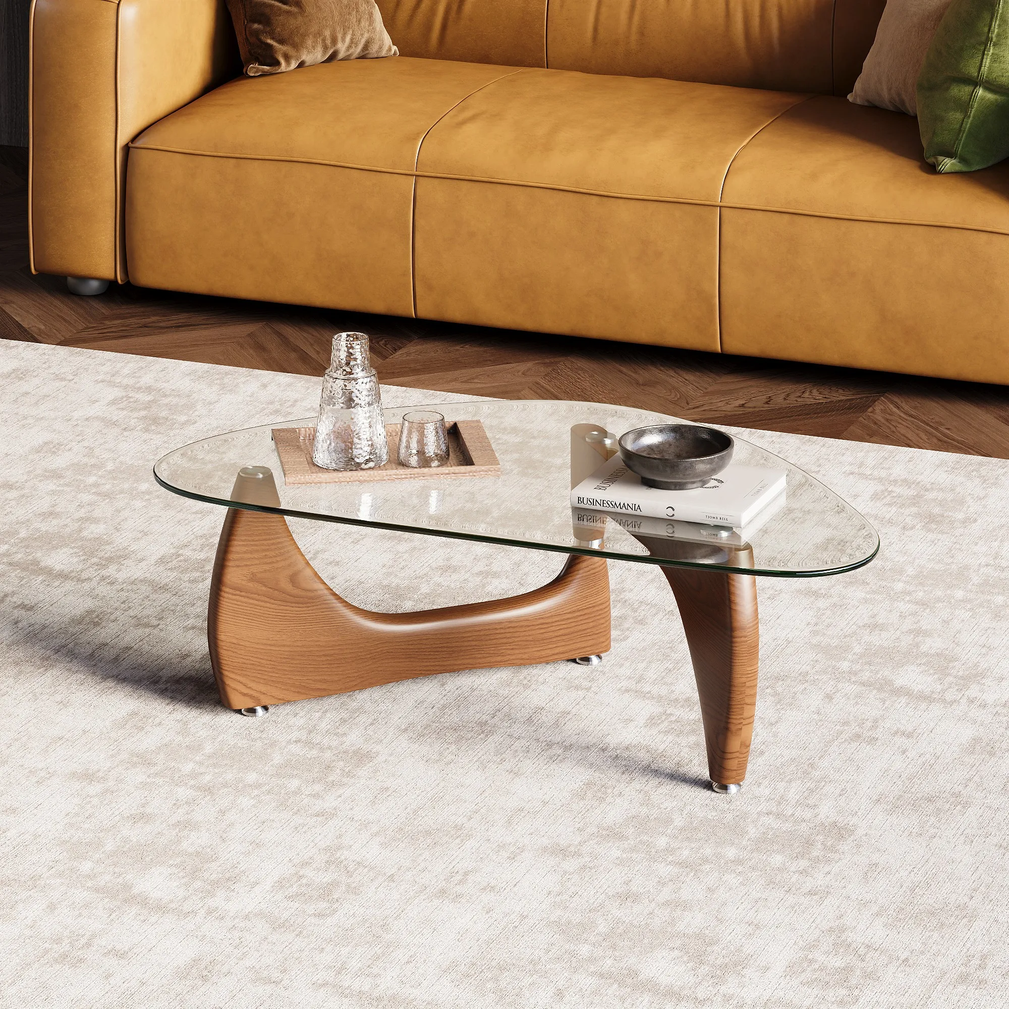 Mid-century modern glass coffee table with sculptural wooden legs placed on a light textured rug, accompanied by a yellow leather sofa and minimalist decor including glassware and a ceramic bowl.

