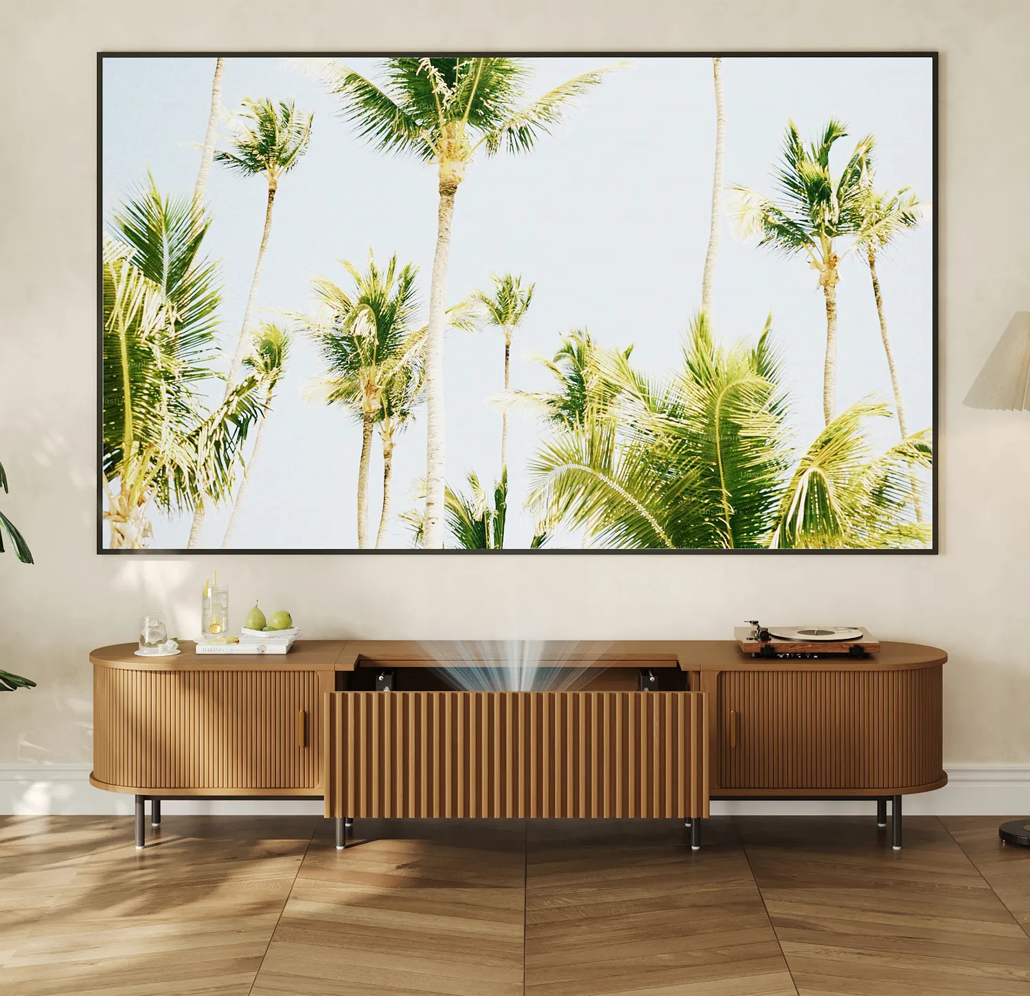 Modern wooden TV stand with slatted doors and built-in projector, set against a tropical palm print backdrop.