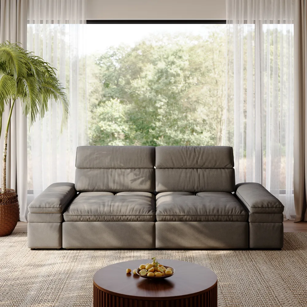 Modern gray power recliner sofa with adjustable headrests, placed in a bright living room with floor-to-ceiling windows and a round wooden coffee table.