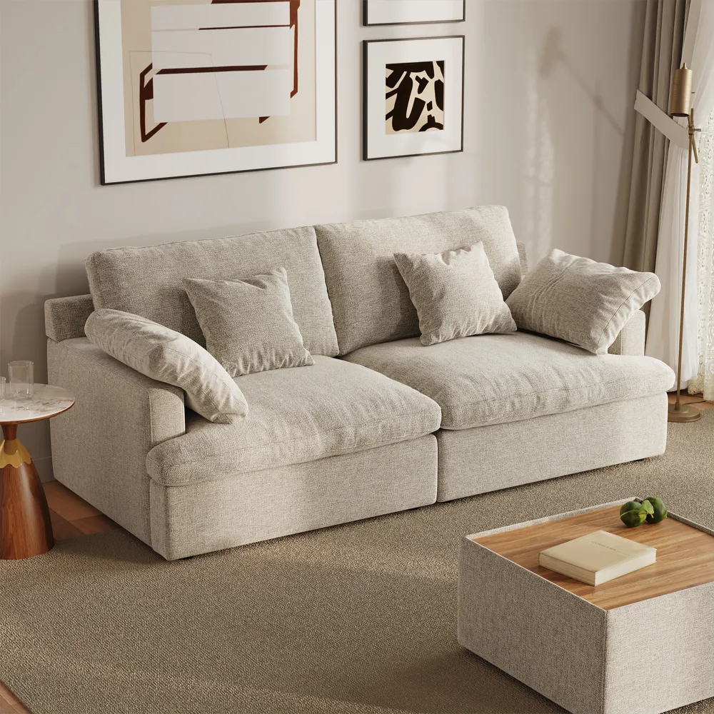 Beige deep-seated fabric sofa with overstuffed cushions in a minimalist living room with warm tones