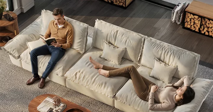 Modern beige sectional sofa with deep cushions, featuring a man reading and a woman relaxing, styled in a cozy living room with wood and neutral accents.