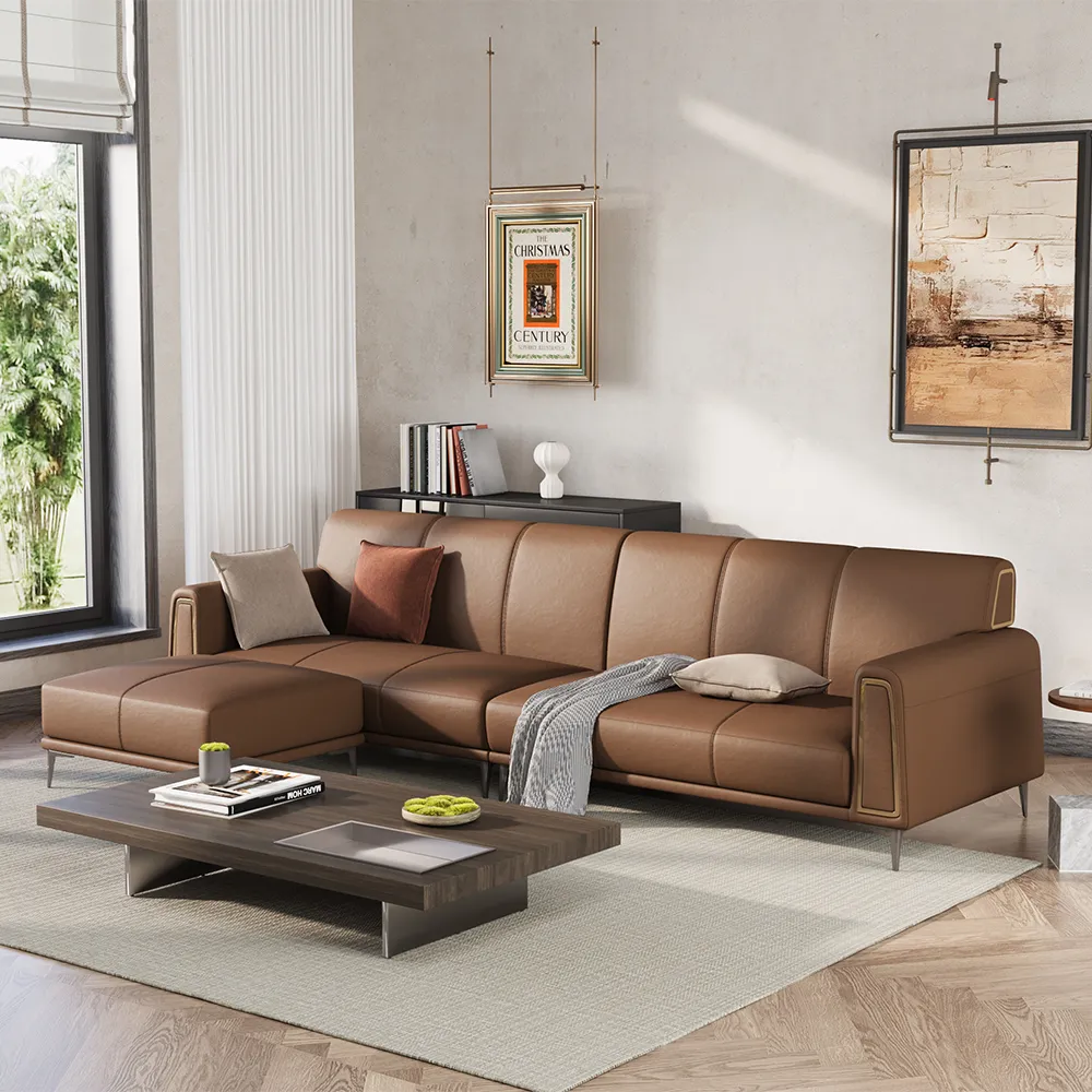 Contemporary brown leather L-shaped sectional sofa with metal legs and accent pillows in a stylish neutral-toned living room