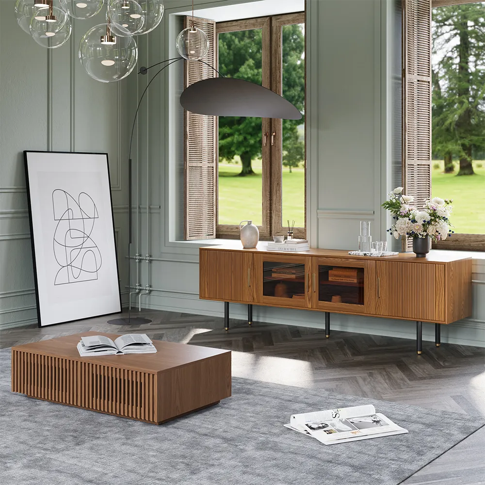 Close-up of a mid-century inspired wall-mounted TV console with fluted doors, glass panels, and brass details under an open window.