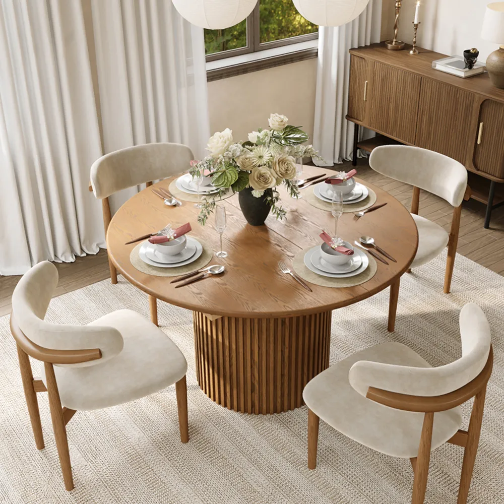 Walnut mid-century modern round dining table set with matching chairs, styled with floral centerpiece and soft neutral tones for a cozy dining space.