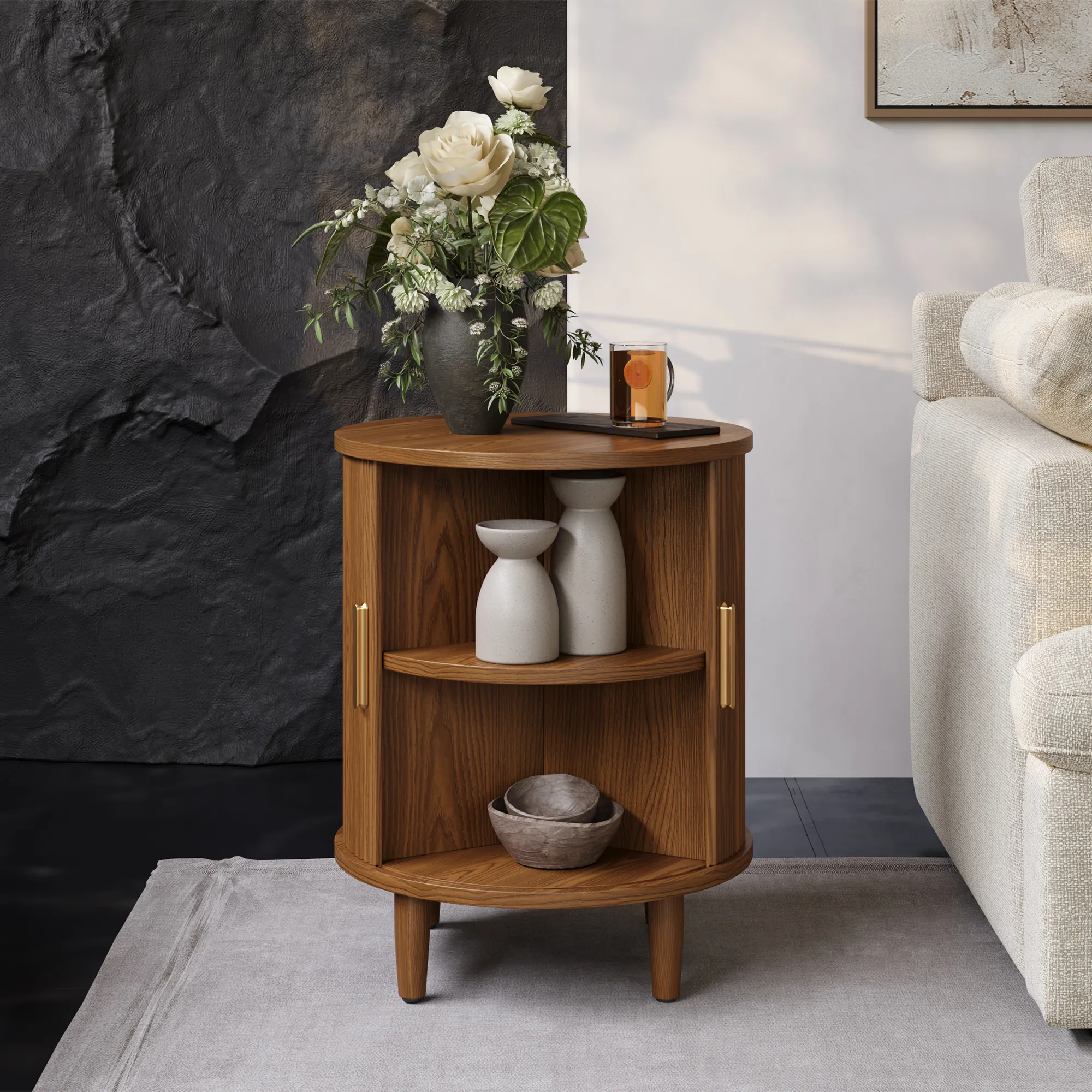 Mid-century modern round walnut side table with sliding tambour door and open storage shelves, styled with vases and a flower arrangement.