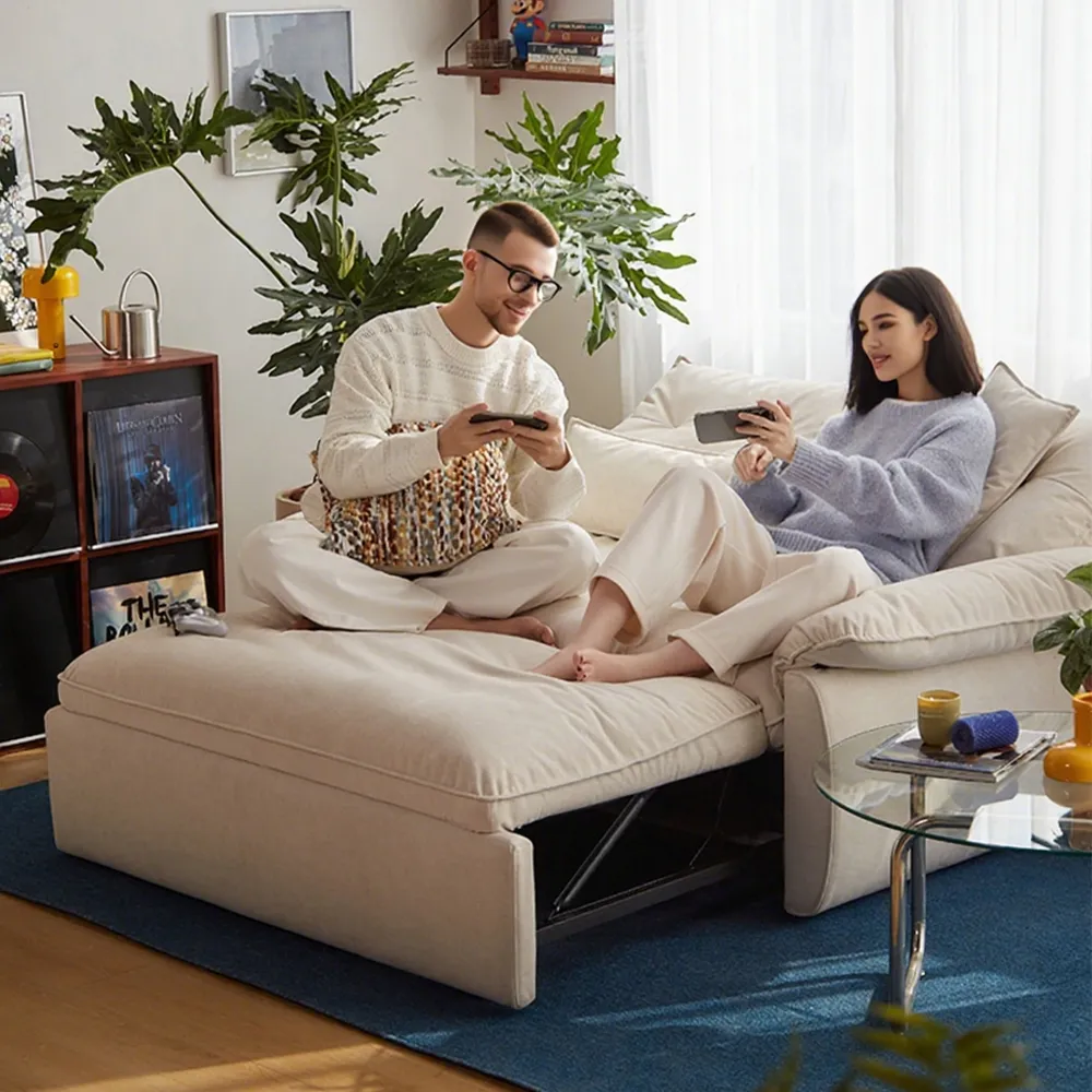 An open full-size pull-out sofa bed with cozy white bedding