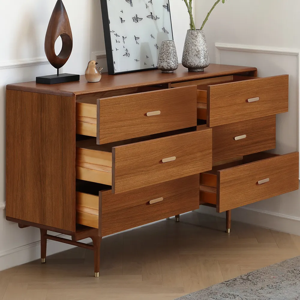 A tall mid-century modern cabinet with six drawers and iconic tapered wood legs, used as a stylish storage piece.