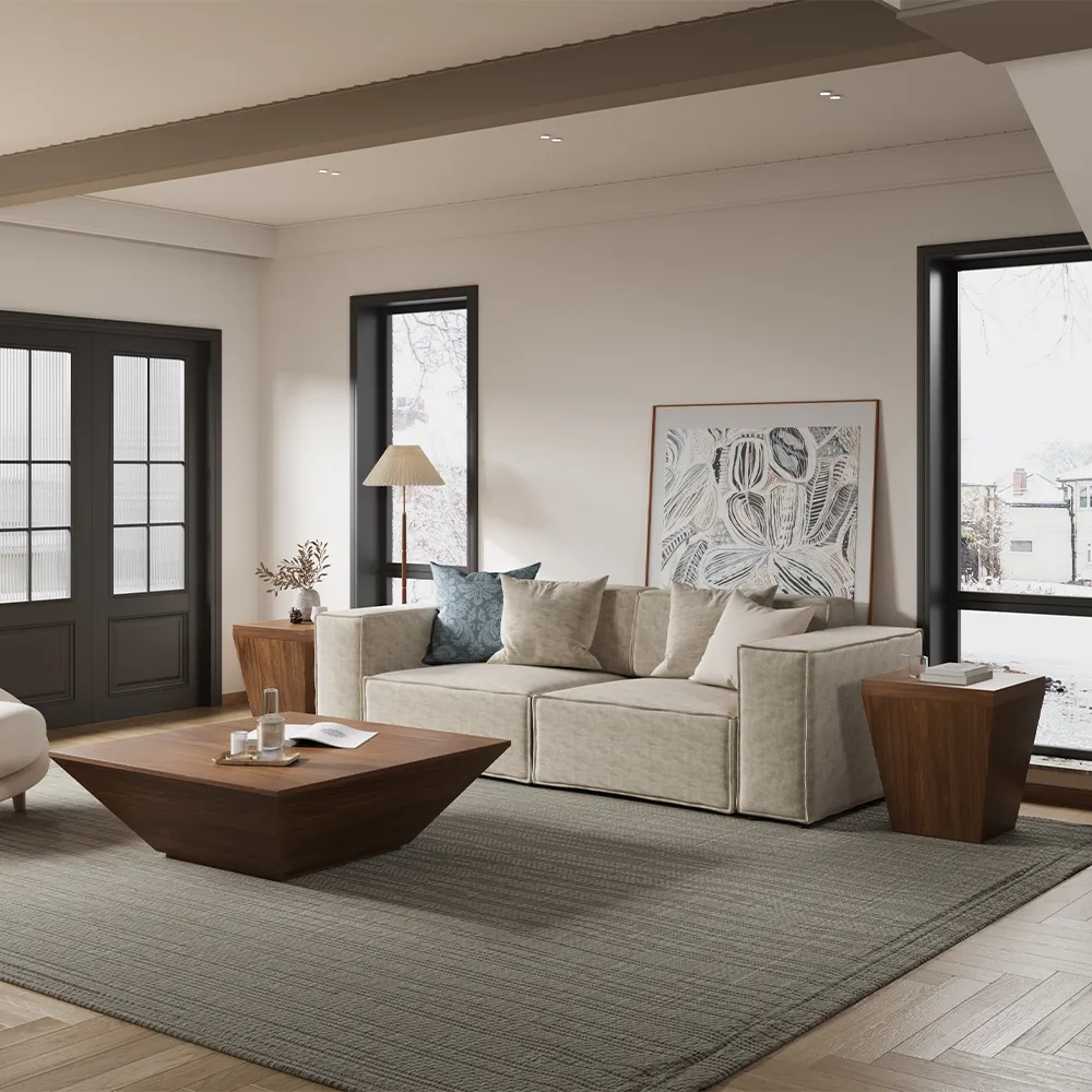 Geometric square drum coffee table with matching wooden side table in a neutral-toned living room with large windows