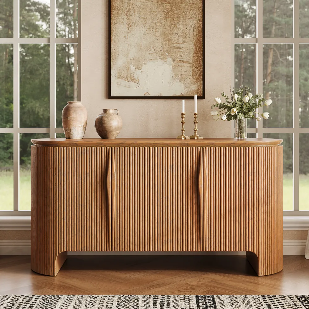Large fluted mid-century modern sideboard in natural wood, styled in a bright dining room with vases and candles, beneath abstract wall art.