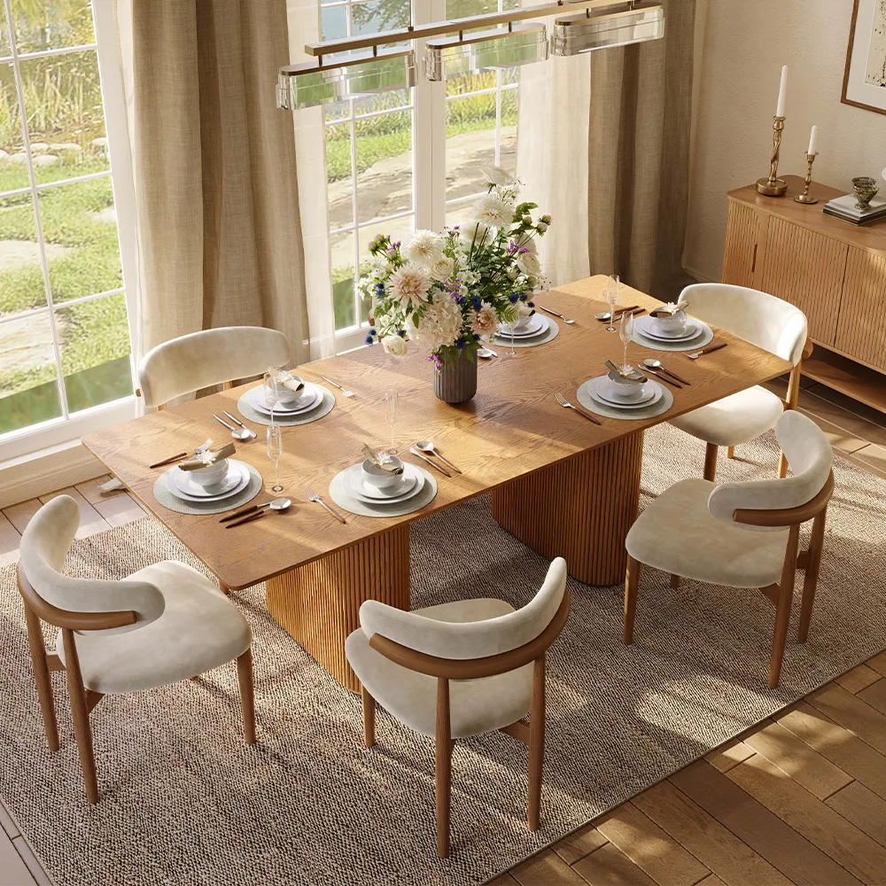 Mid-century modern fluted rectangular wood dining table paired with sculptural velvet chairs and neutral decor, set in a sunlit dining room with minimalist touches.