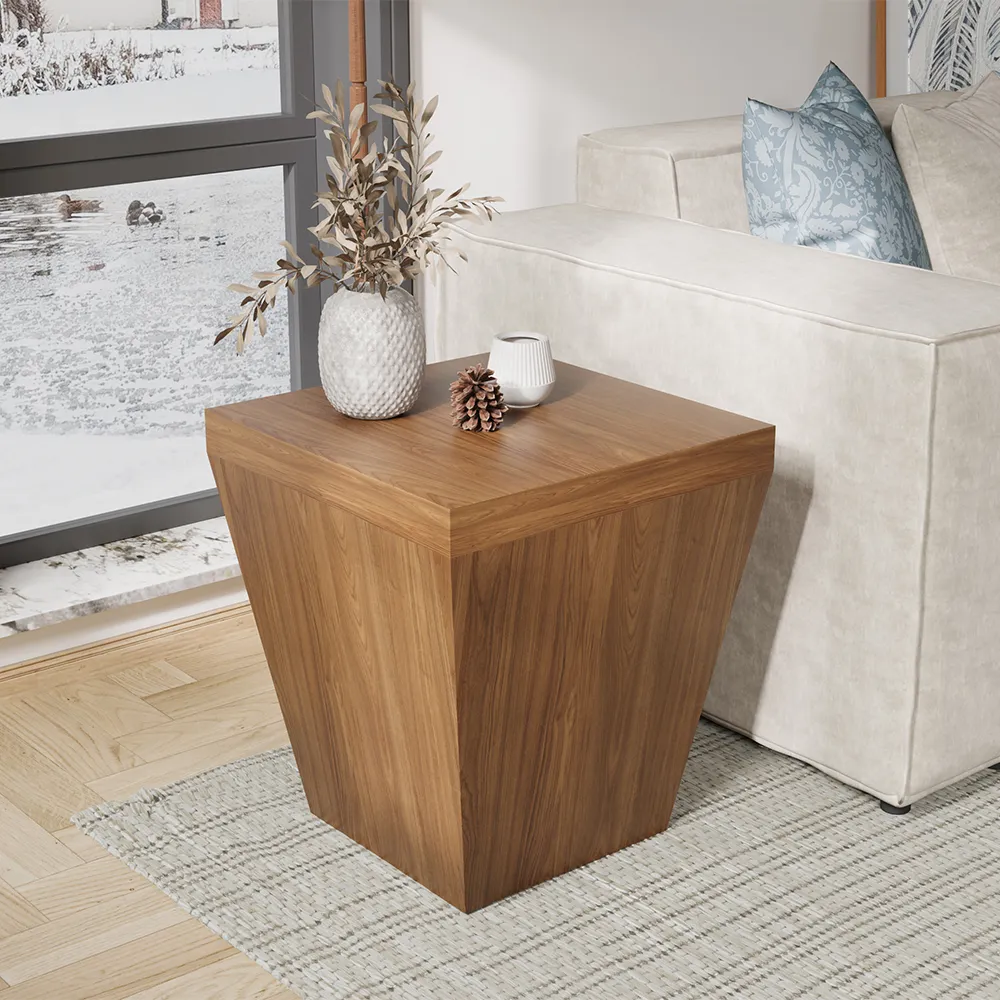 Tapered square mid-century modern walnut side table styled with ceramic vase and pinecone beside a cream sofa.