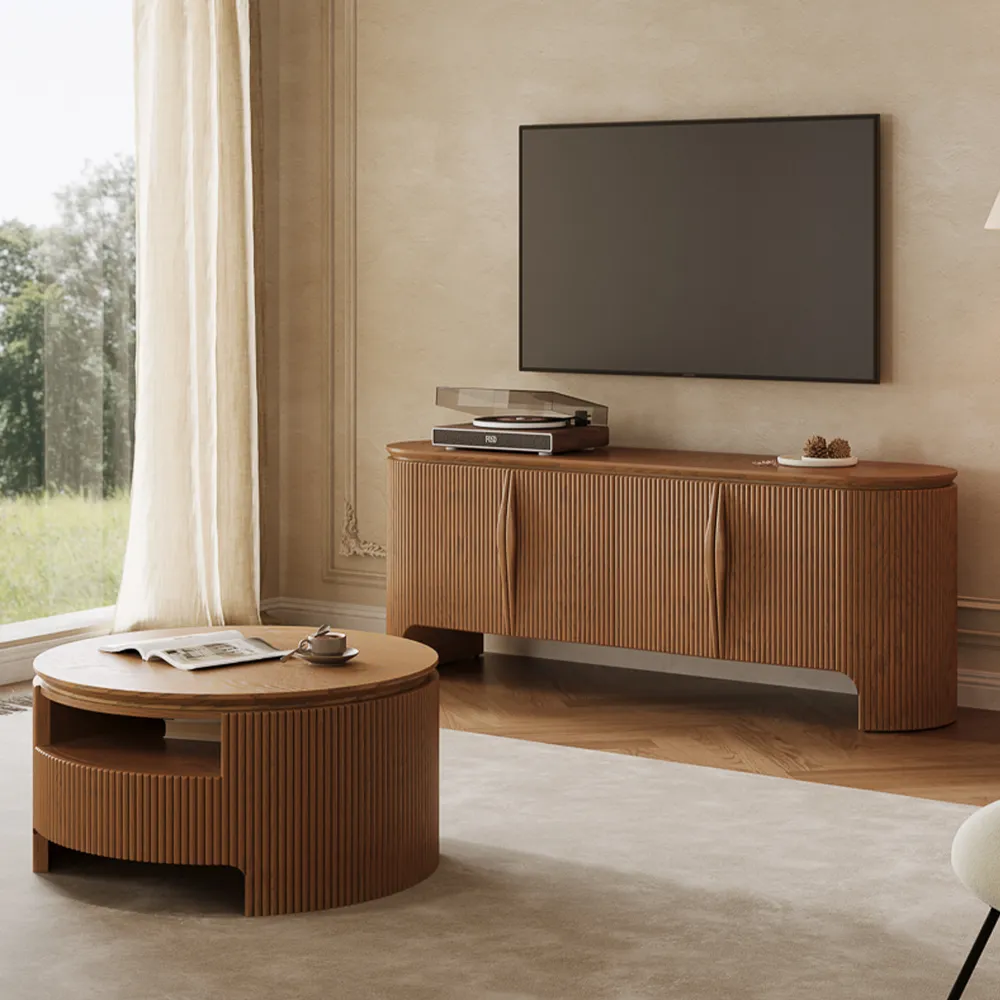 Elegant fluted wood TV stand with round coffee table and wall-mounted TV in a sunlit modern living room