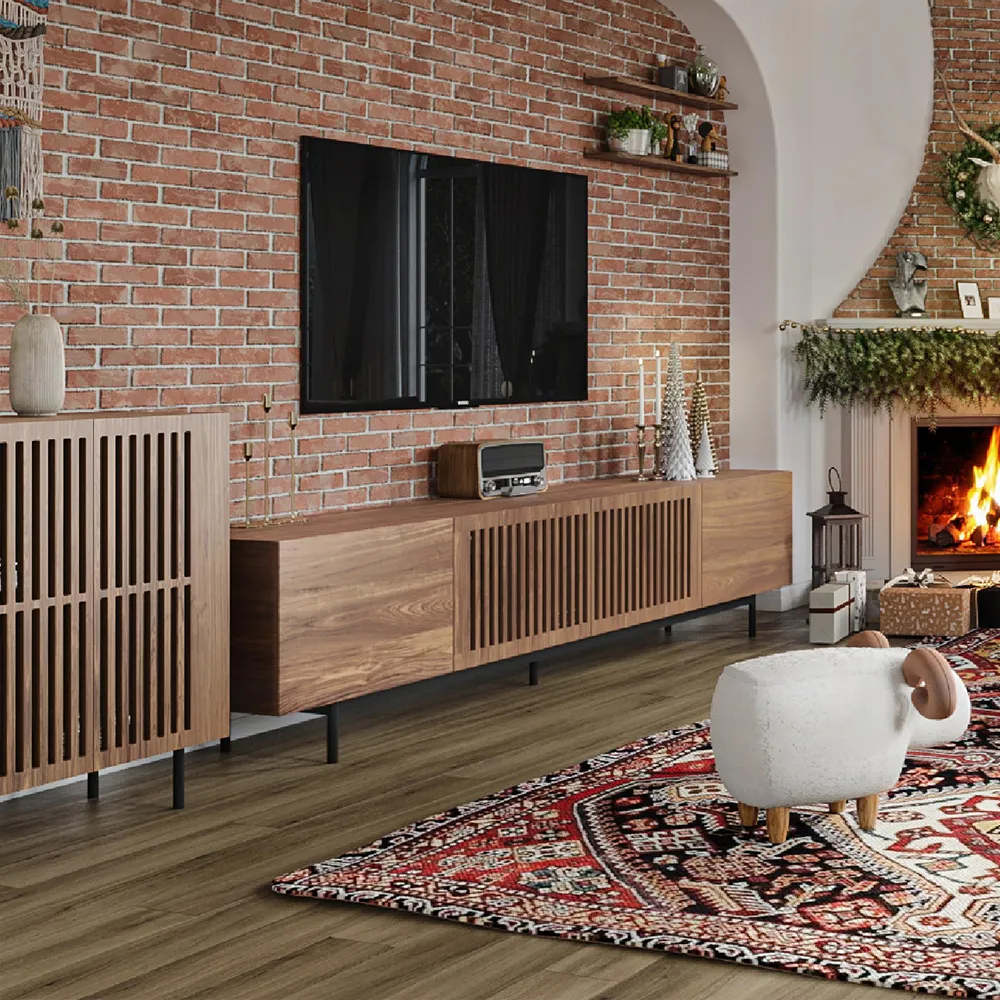 Mid-century modern slatted TV console and side cabinet set against exposed brick wall and fireplace decor