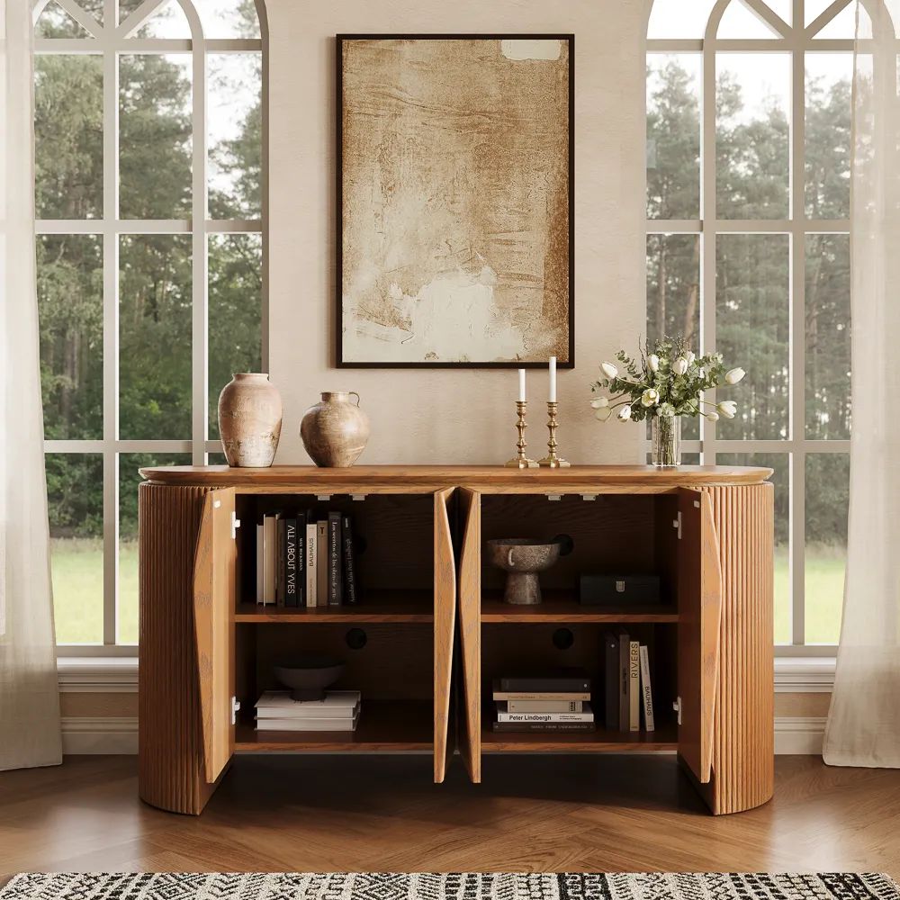 Mid-century modern curved storage cabinet with fluted detailing, shown open to reveal adjustable shelves with books and home accessories.