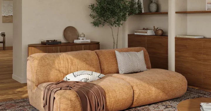 Rust-colored mid-century modern sofa in a warm-toned living room with open shelving, wood accents, and a patterned Persian-style rug.
