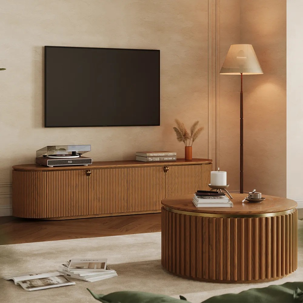Mid-century modern fluted TV stand and round coffee table in walnut finish, styled with turntable and books in a warm-toned minimalist living room.